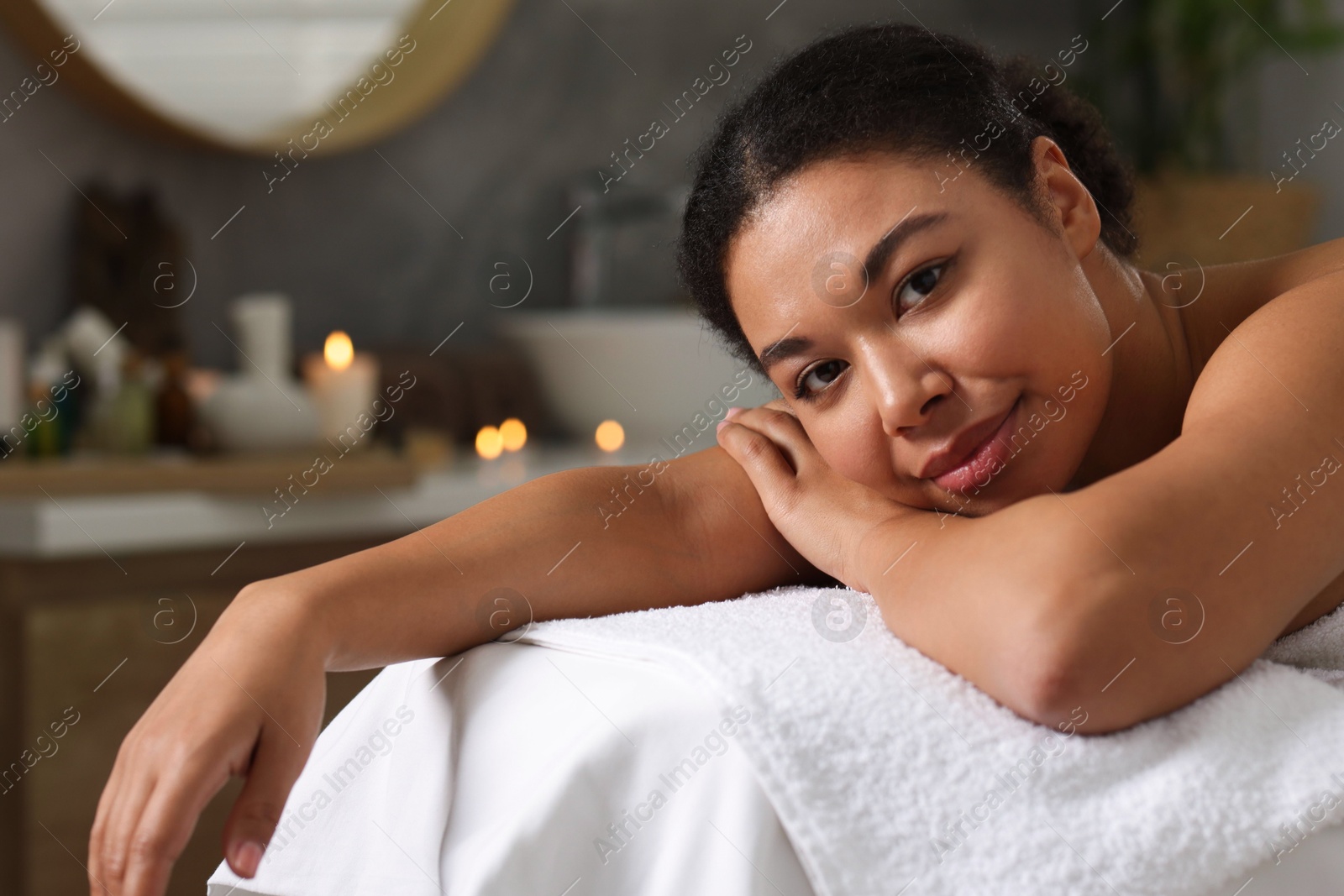 Beautiful woman relaxing on massage couch in spa salon Photo of Beautiful woman relaxing on massage couch in spa salon