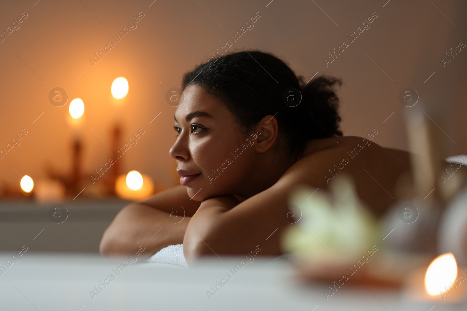 Beautiful woman relaxing on massage couch in spa salon Photo of Beautiful woman relaxing on massage couch in spa salon