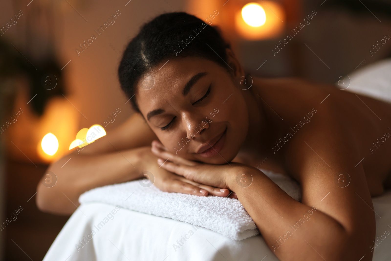 Beautiful woman relaxing on massage couch in spa salon Photo of Beautiful woman relaxing on massage couch in spa salon