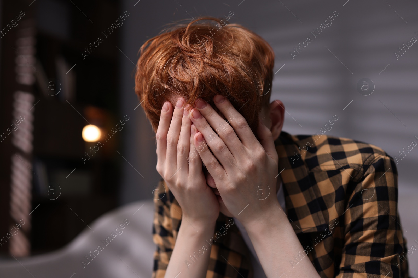 Teen problems. Depressed teenage boy at home Photo of Teen problems. Depressed teenage boy at home