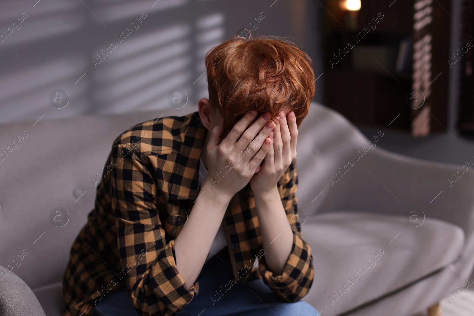 Teen problems. Depressed teenage boy on sofa at home Photo of Teen problems. Depressed teenage boy on sofa at home