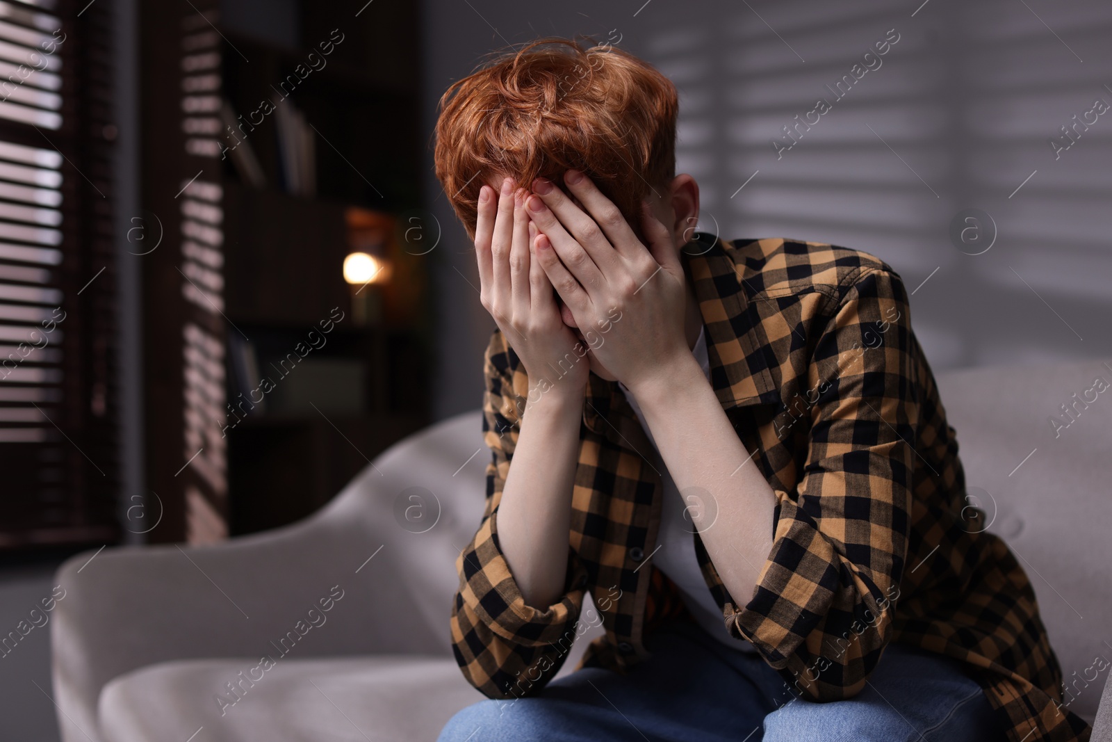 Teen problems. Depressed teenage boy on sofa at home Photo of Teen problems. Depressed teenage boy on sofa at home