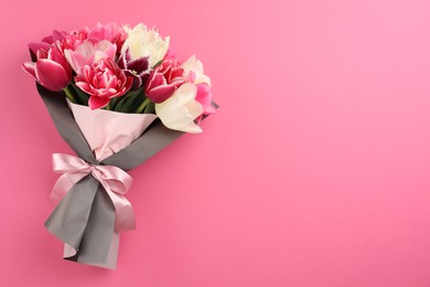 Photo of Bouquet of beautiful tulips on pink background, top view. Space for text