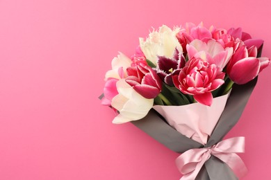 Photo of Bouquet of beautiful tulips on pink background, top view