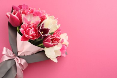 Photo of Bouquet of beautiful tulips on pink background, top view. Space for text