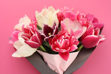 Photo of Bouquet of beautiful tulips on pink background, closeup