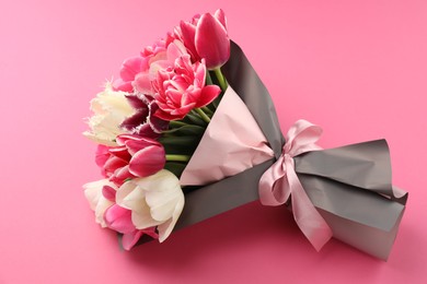 Photo of Bouquet of beautiful tulips on pink background