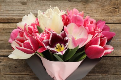 Photo of Bouquet of beautiful tulips on wooden background, closeup
