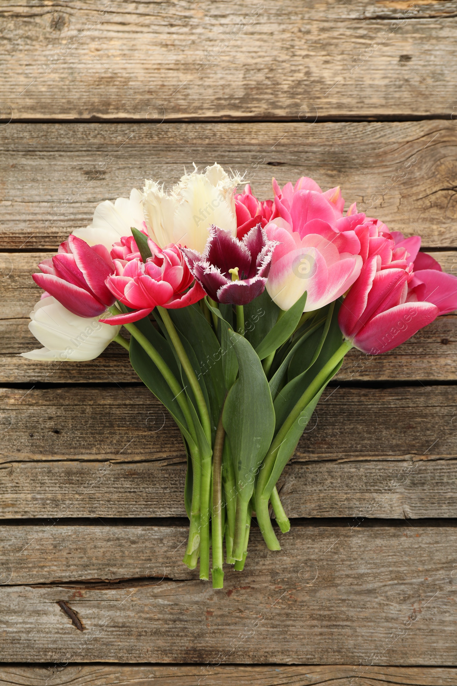 Beautiful tulips on wooden background, top view Photo of Beautiful tulips on wooden background, top view