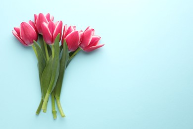 Photo of Beautiful tulip flowers on light background, top view. Space for text