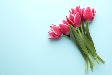 Photo of Beautiful tulip flowers on light background, top view. Space for text