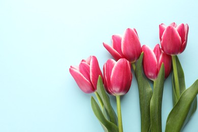 Photo of Beautiful tulip flowers on light background, top view. Space for text