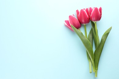Photo of Beautiful tulip flowers on light background, top view. Space for text