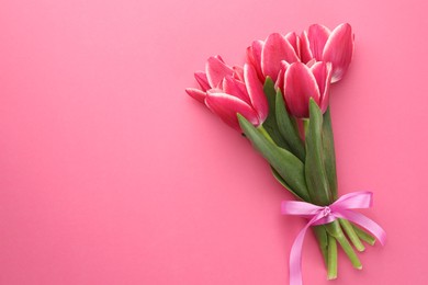 Photo of Bouquet of beautiful tulips on pink background, top view. Space for text