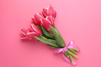 Photo of Bouquet of beautiful tulips on pink background, top view