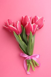 Photo of Bouquet of beautiful tulips on pink background, top view