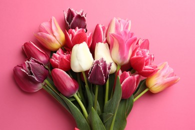 Photo of Bouquet of beautiful tulips on pink background, top view