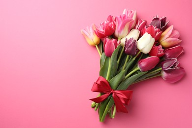 Photo of Bouquet of beautiful tulips on pink background, top view. Space for text