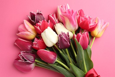 Photo of Bouquet of beautiful tulips on pink background, top view