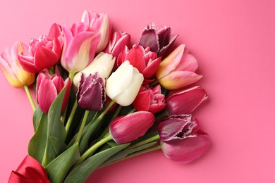 Photo of Bouquet of beautiful tulips on pink background, top view