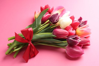 Photo of Bouquet of beautiful tulips on pink background, closeup