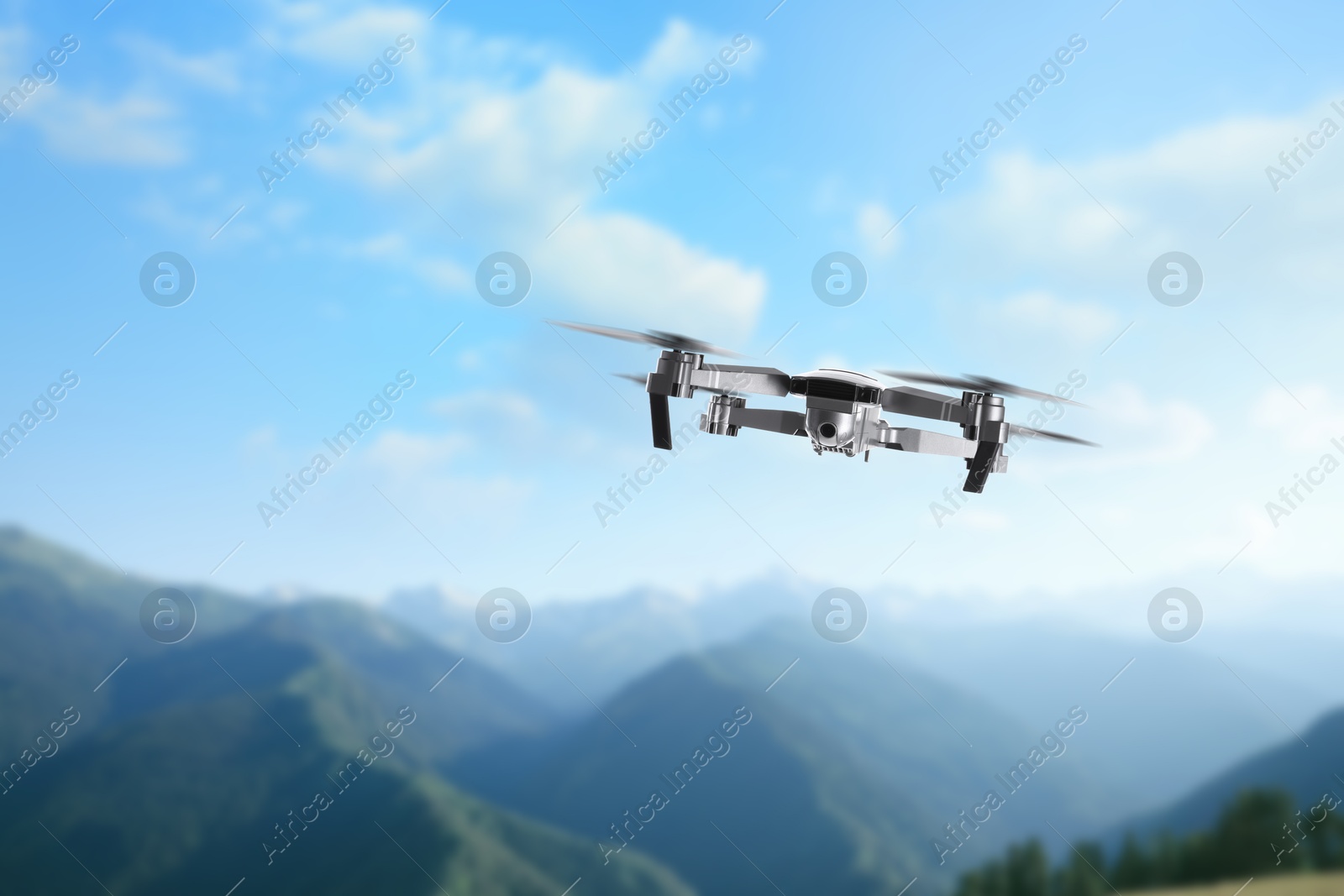 Drone with camera flying in mountains. Unmanned aerial vehicle for surveillance Image of Drone with camera flying in mountains. Unmanned aerial vehicle for surveillance
