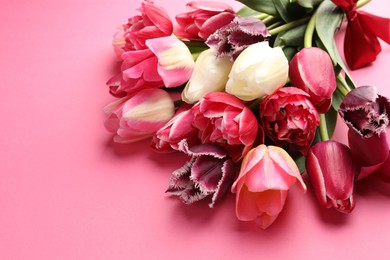 Photo of Beautiful tulip flowers on pink background, closeup