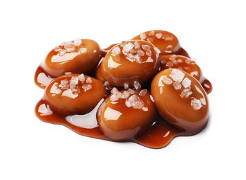 Photo of Tasty sweet candies, salt and caramel sauce isolated on white