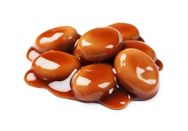 Photo of Tasty sweet candies and caramel sauce isolated on white