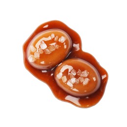Photo of Tasty sweet candies, salt and caramel sauce isolated on white, top view