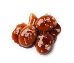 Photo of Tasty sweet candies, salt and caramel sauce isolated on white, top view