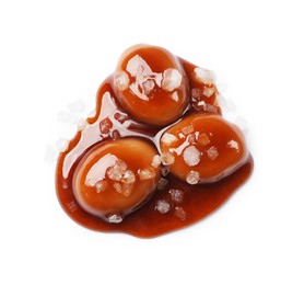 Photo of Tasty sweet candies, salt and caramel sauce isolated on white, top view