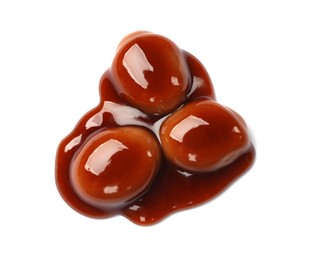 Photo of Tasty sweet candies and caramel sauce isolated on white, top view