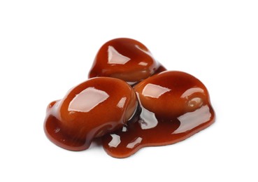 Photo of Tasty sweet candies and caramel sauce isolated on white