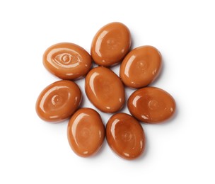 Photo of Tasty sweet caramel candies isolated on white, top view