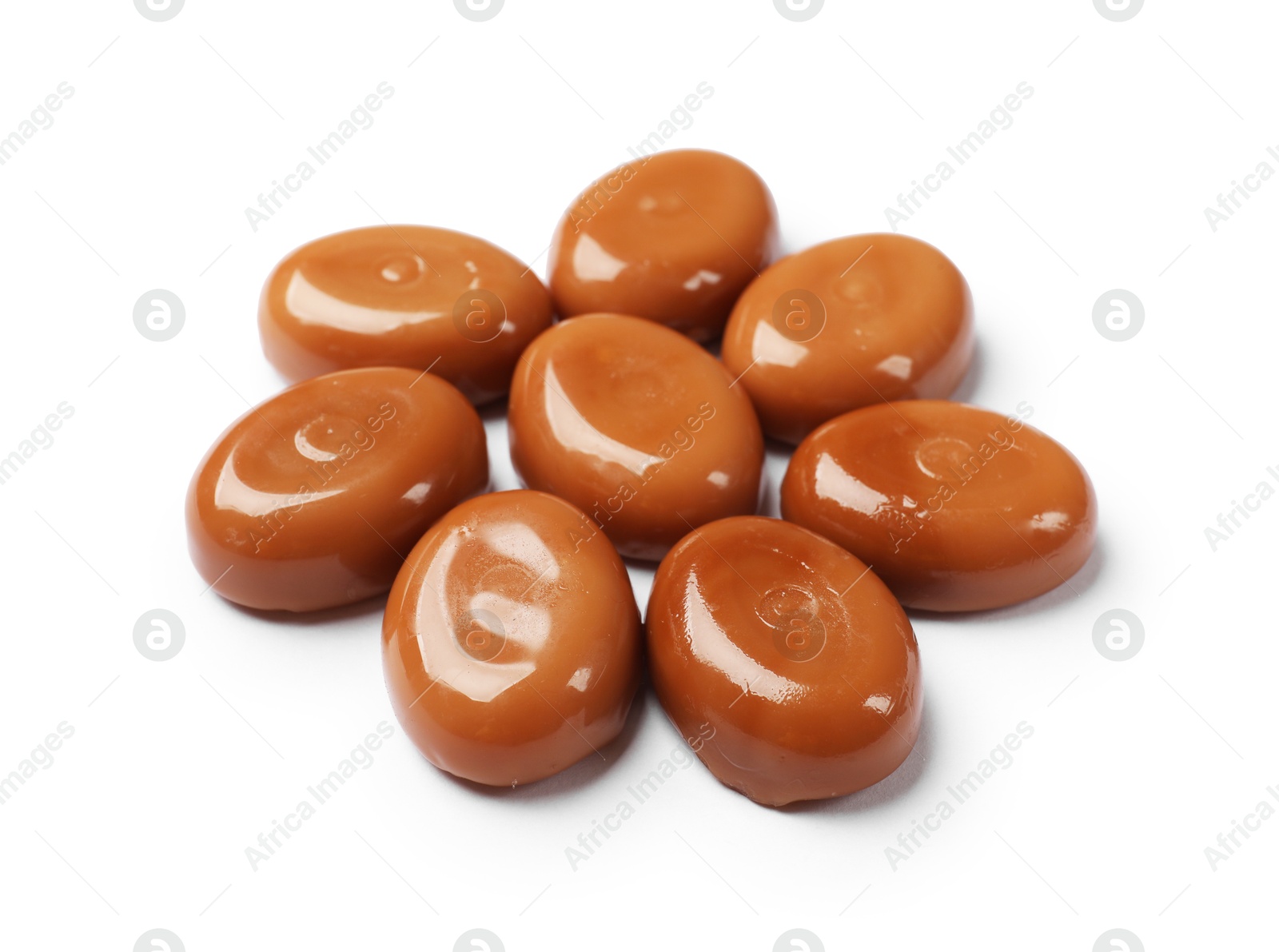 Photo of Tasty sweet caramel candies isolated on white