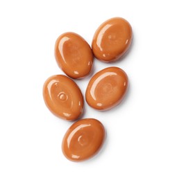 Photo of Tasty sweet caramel candies isolated on white, top view