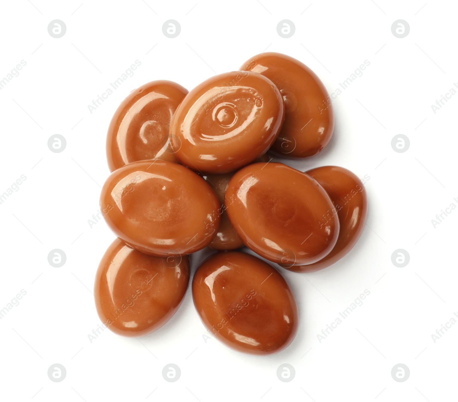 Photo of Tasty sweet caramel candies isolated on white, top view