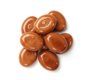 Photo of Tasty sweet caramel candies isolated on white, top view