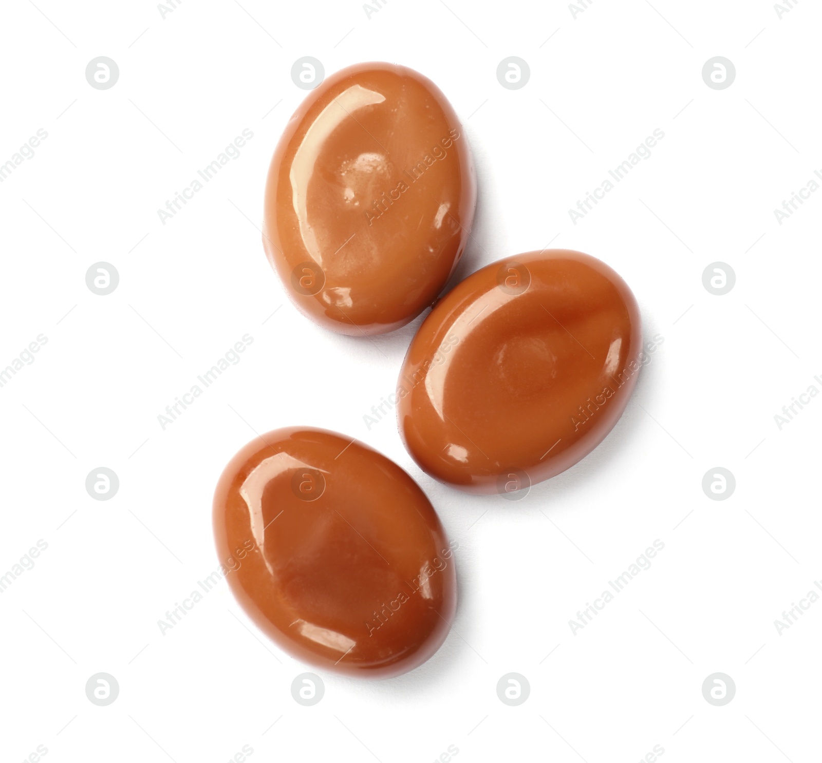Tasty sweet caramel candies isolated on white, top view Photo of Tasty sweet caramel candies isolated on white, top view