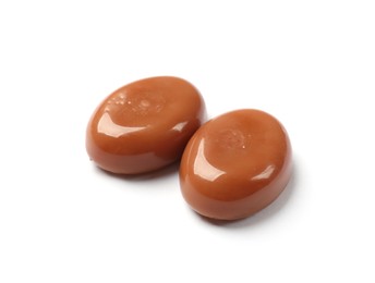 Photo of Tasty sweet caramel candies isolated on white
