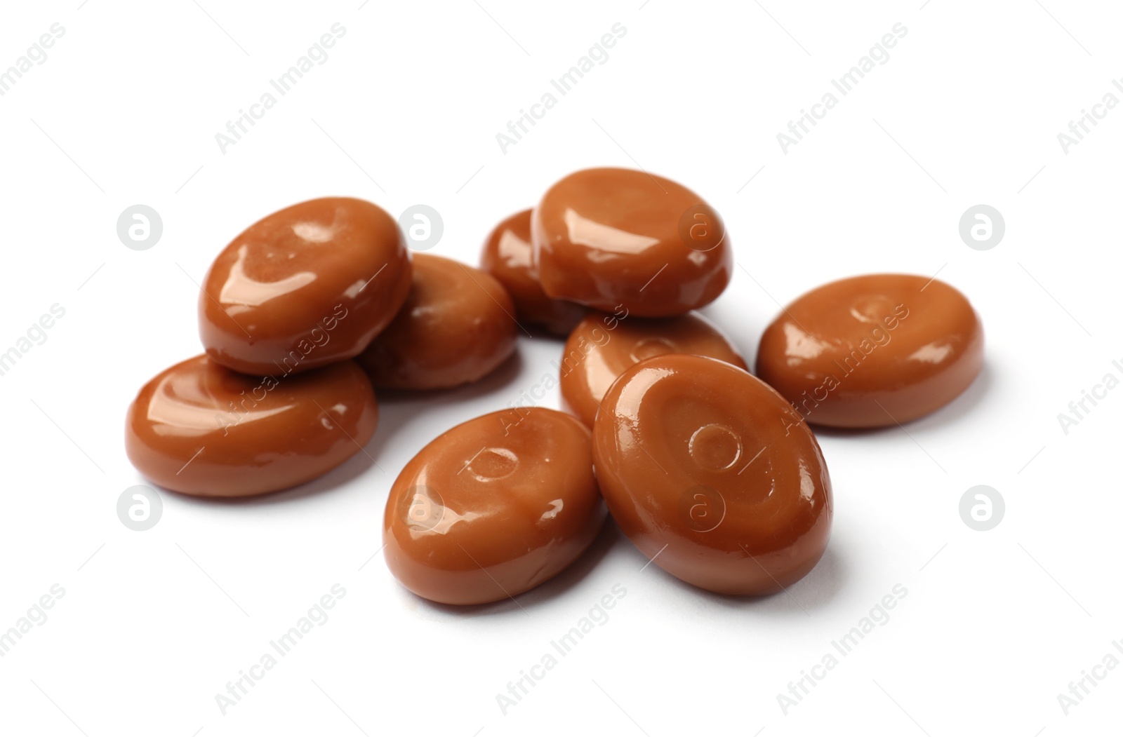 Photo of Tasty sweet caramel candies isolated on white