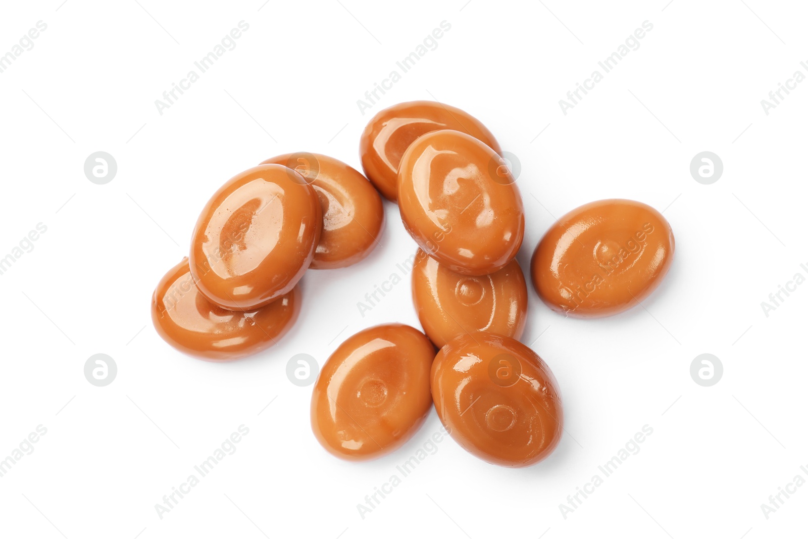 Photo of Tasty sweet caramel candies isolated on white, top view