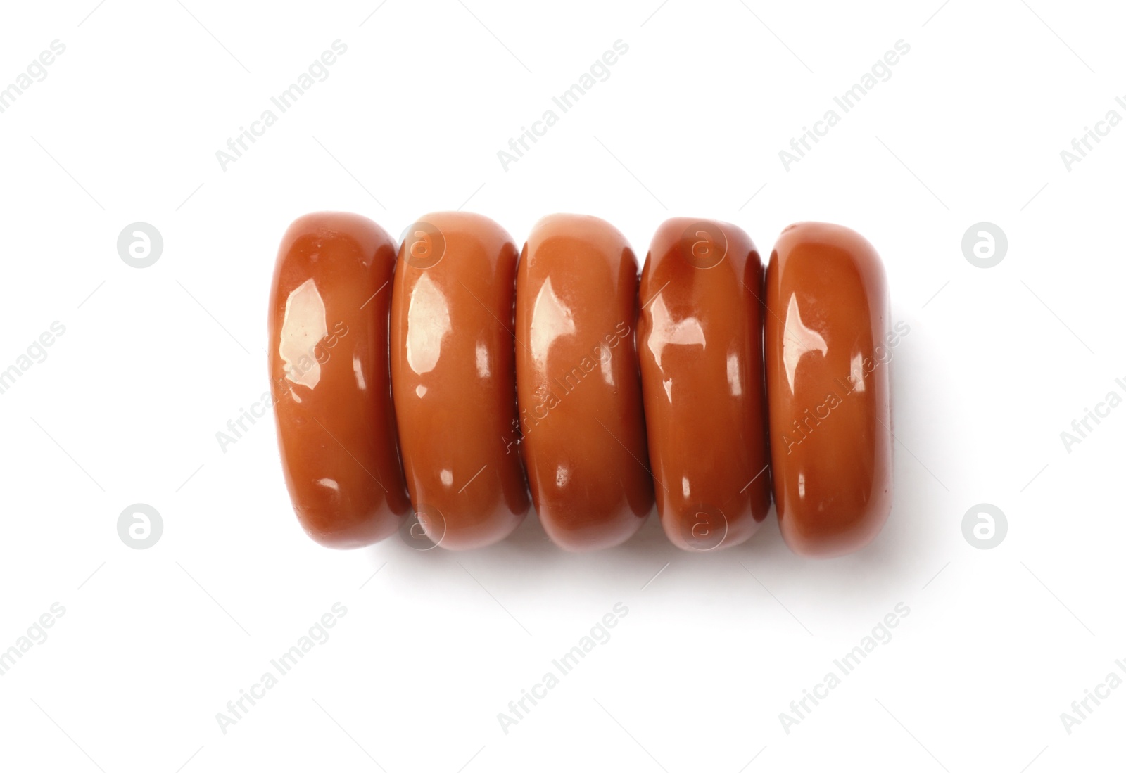 Photo of Tasty sweet caramel candies isolated on white, top view