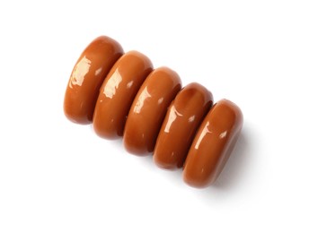 Photo of Tasty sweet caramel candies isolated on white, top view
