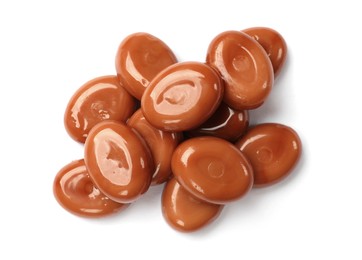 Photo of Tasty sweet caramel candies isolated on white, top view