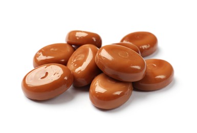 Photo of Tasty sweet caramel candies isolated on white