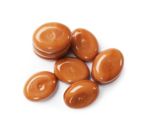 Photo of Tasty sweet caramel candies isolated on white, top view