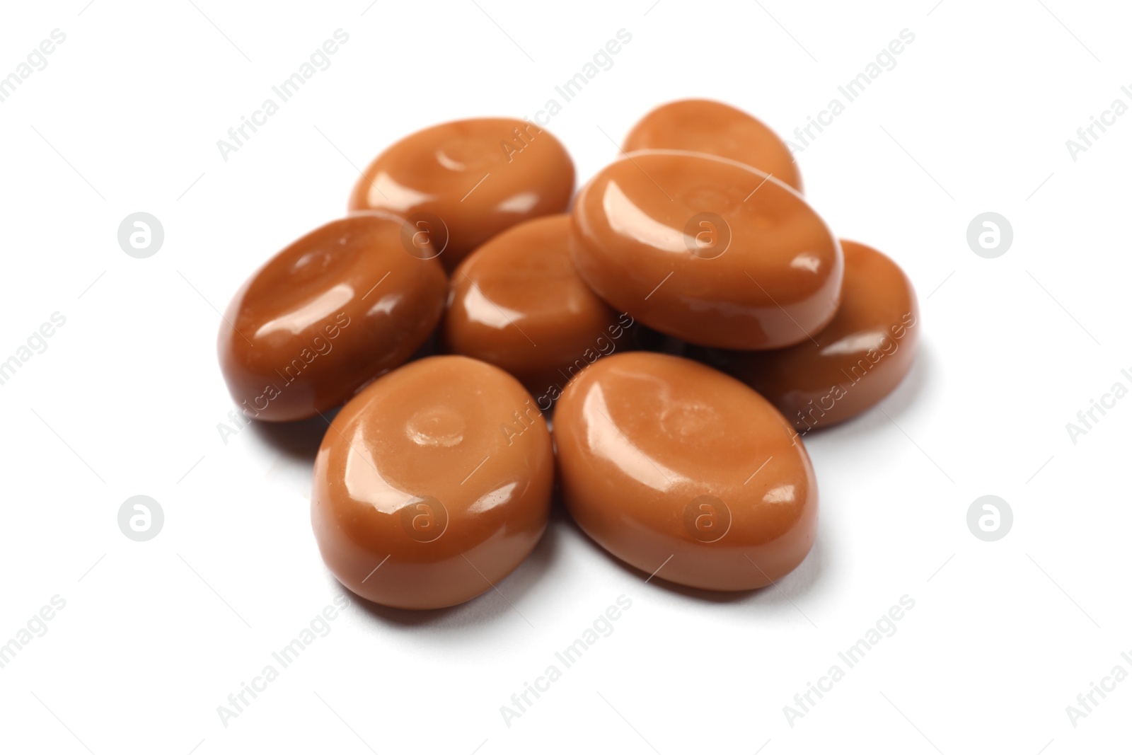 Photo of Tasty sweet caramel candies isolated on white