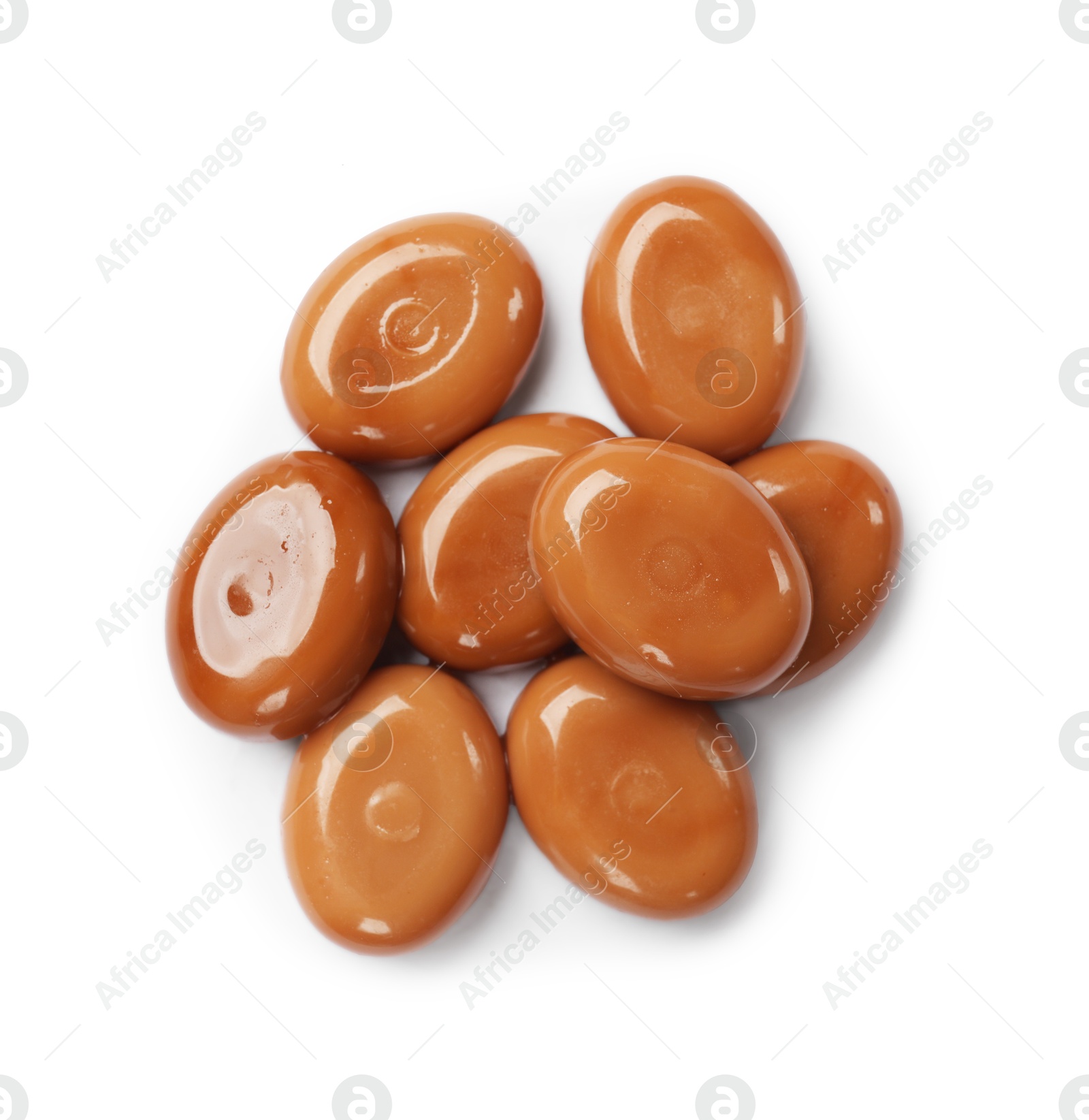 Photo of Tasty sweet caramel candies isolated on white, top view